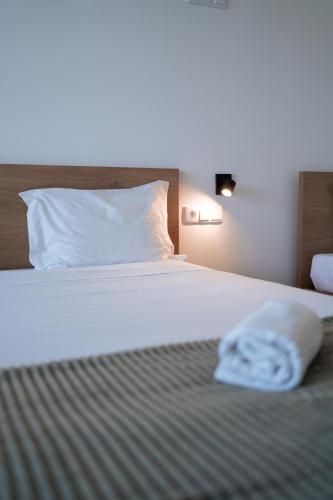 a bed in a hotel room with a towel on it at Marinhas Bed & Breakfast in Esposende