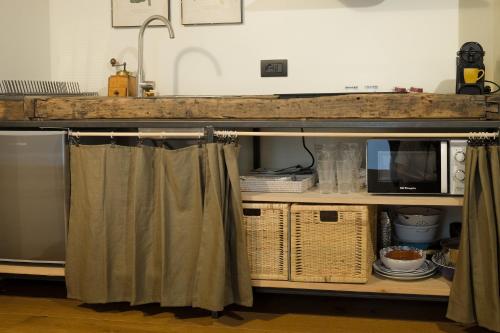 a kitchen with a counter with a microwave and curtains at Casa del Moro in Mercato Saraceno