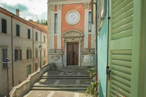 a door to a building with a clock on it at Casa del Moro in Mercato Saraceno