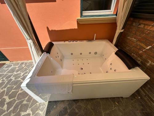 a bath tub sitting outside of a building at BolognaRoomscom - Isaia Garden Private Garden Spa Bath in Bologna