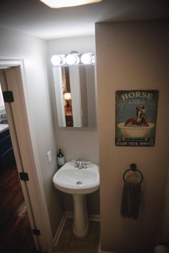 a bathroom with a sink and a mirror at 1939 Four Bed Rustic Escape by Casino in Ranson