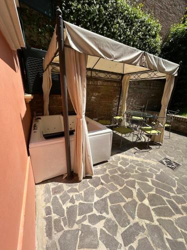 a tent on a patio with a table and a tub at BolognaRoomscom - Isaia Garden Private Garden Spa Bath in Bologna