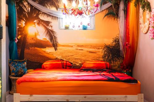 a bedroom with a bed with a painting of a beach at Princess Palace in Gdańsk