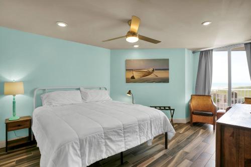 a bedroom with a bed and a ceiling fan at St Regis 1105 in Chadwick Acres