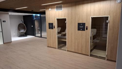 a room with sliding glass doors in a store at Pratum Plus prywatny ogród z tarasem grill leżaki in Mikołajki