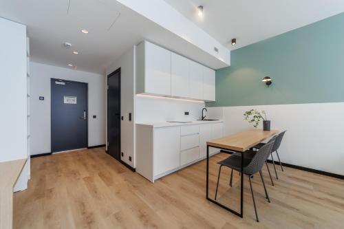a kitchen and dining room with a table and chairs at River Stay Apartments in Tallinn