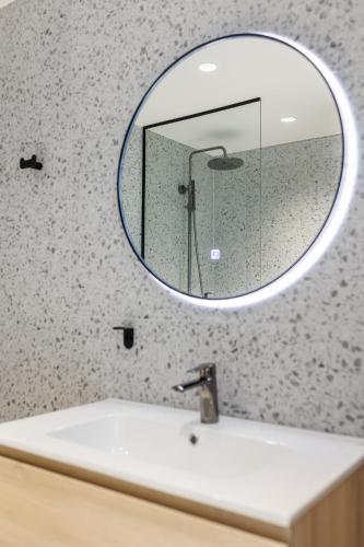 a bathroom with a mirror over a sink at River Stay Apartments in Tallinn