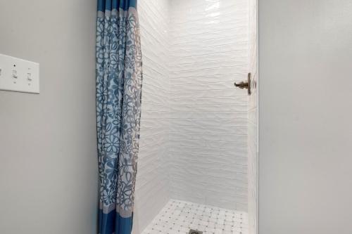 a shower with a blue shower curtain in a bathroom at 3530 Island Drive in North Topsail Beach