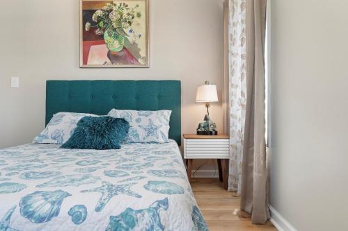 a bedroom with a bed with a blue headboard at 3530 Island Drive in North Topsail Beach