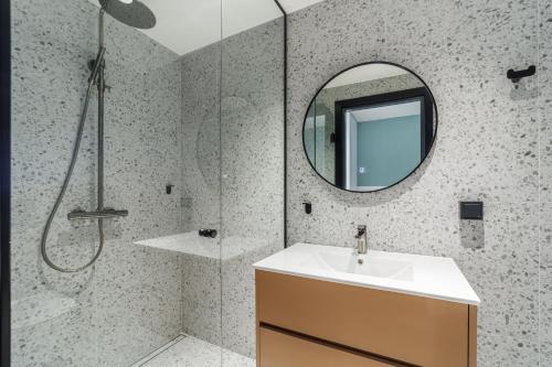 a bathroom with a sink and a mirror at River Stay Apartments in Tallinn