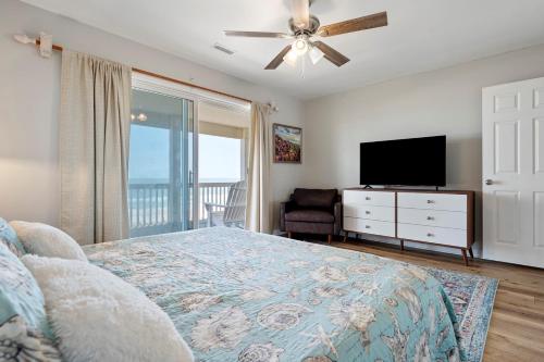 a bedroom with a bed and a flat screen tv at 3530 Island Drive in North Topsail Beach