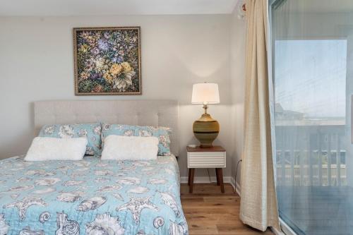 a bedroom with a bed and a painting on the wall at 3530 Island Drive in North Topsail Beach