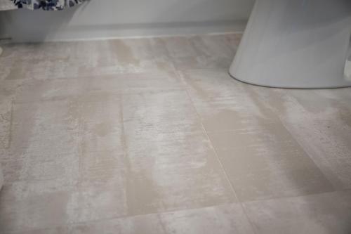 a tile floor with a white table in a room at 3530 Island Drive in North Topsail Beach