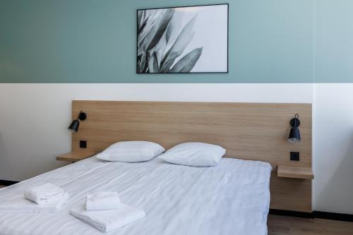 a bedroom with a bed with two towels on it at River Stay Apartments in Tallinn