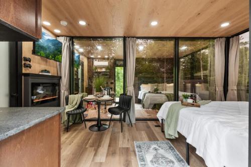 a bedroom with a bed and a room with a fireplace at Secluded Mirror Cabin-Luxury-Hot Tub-FirePit in Sevierville