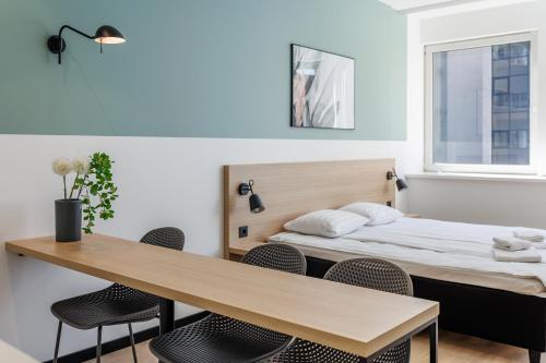 a room with a bed and a table and chairs at River Stay Apartments in Tallinn