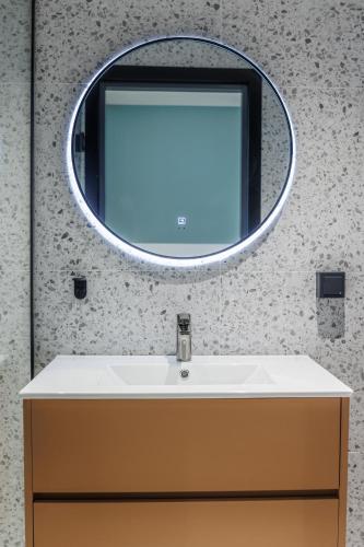 a bathroom with a sink and a mirror at River Stay Apartments in Tallinn
