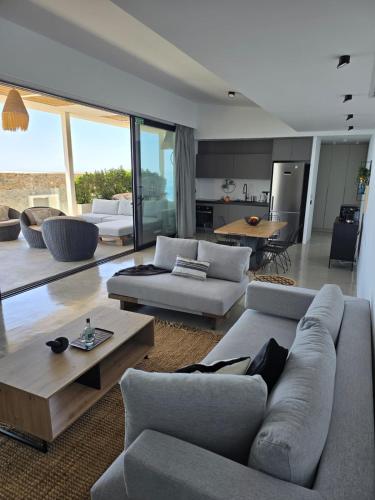 a living room with a couch and a table at The Cliff in Melínta