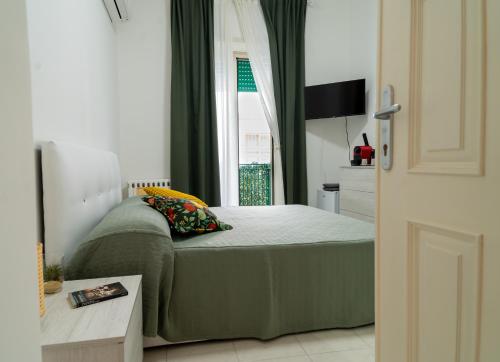 a bedroom with a bed and a window at Casa Pirandello in Terracina