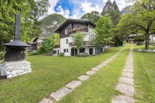 a house with a stone path in front of it at Garden Apartment Relax in Barco