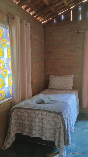 Ένα ή περισσότερα κρεβάτια σε δωμάτιο στο Camping e pousada dos sonhos