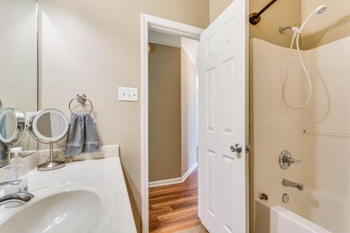 a bathroom with a sink and a mirror at 11 Mi to Dtwn Little Rock Home with Large Deck! in Mabelvale