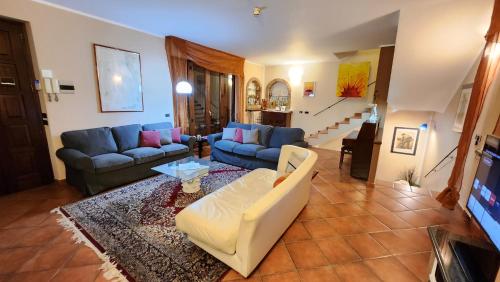a living room with two couches and a tv at Casa Caginia 300mqgiardinopalestra e biliardo in Tigliole