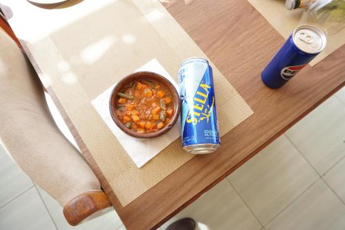 a table with a bowl of food and a can of chips at Merry Land Hotel & Roof Top Nile Restaurant Luxor in Luxor