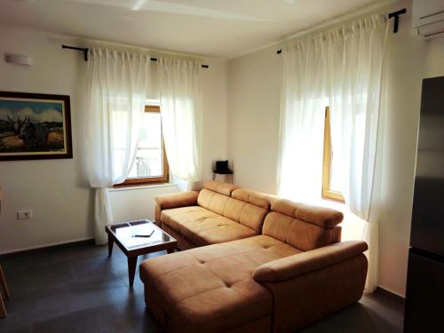 a living room with a couch and a table at Apartment Veronica - Spacious 3BR Townhouse for 6 Guests at Great Value in Brtonigla
