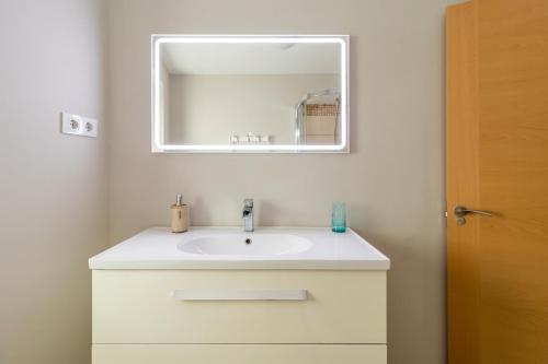 a bathroom with a white sink and a mirror at La Casita De La Pitufa in Vargas