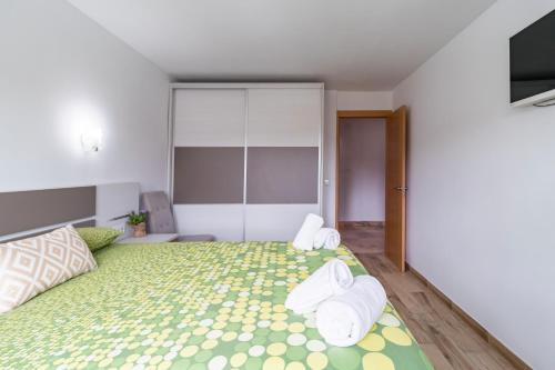 a bedroom with a large bed with towels on it at La Casita De La Pitufa in Vargas