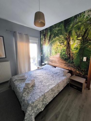 a bedroom with a palm tree mural on the wall at Elli's House in Keramoti