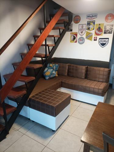 a living room with a couch under the stairs at Stilo Duplex En Punta Carretas in Montevideo