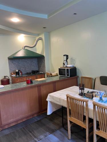 Una cocina con encimera y mesa con sillas. en Yellow Fox, en Ereván