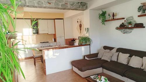 a living room with a couch and a kitchen at Ruggiero "Casa Vacanze" in Vallo della Lucania