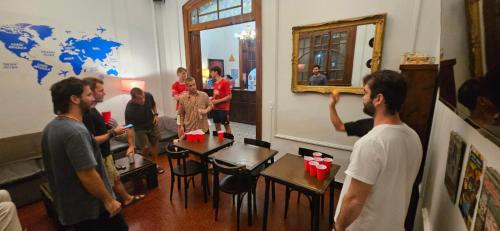 a group of people standing in a room at Play Hostel Arcos in Buenos Aires