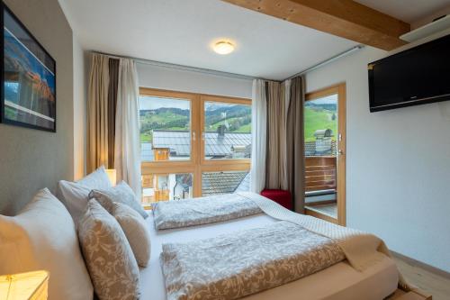 a bedroom with a bed and a large window at Apartments Irene in La Villa