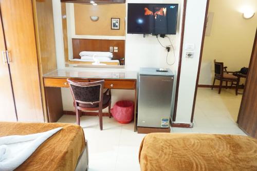 Postel nebo postele na pokoji v ubytování New Saint Catherine Hotel