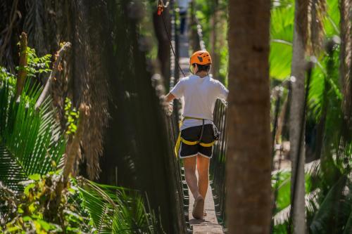 a person walking on a path through the forest at Dreams Bahia Mita Surf and Spa - All Inclusive in Punta Mita