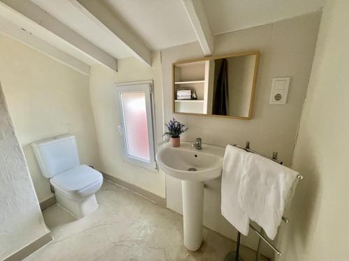 a white bathroom with a sink and a toilet at Casina Fiore - 34601 in Suesa