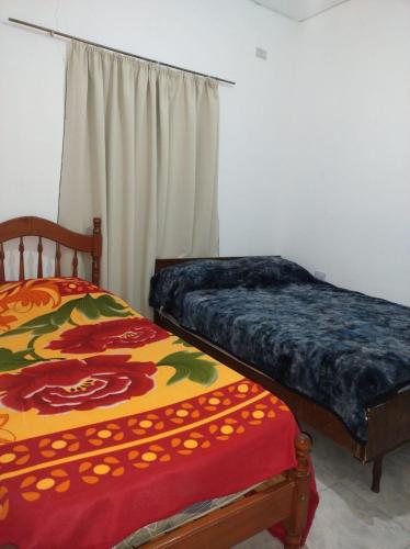 two beds sitting next to each other in a bedroom at Finca LA Soñada in Santiago del Estero