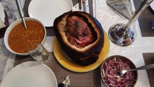 a table with a plate of food on a table at Alpina Panoramic in Moisei