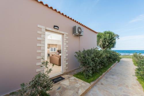 a house with a door leading to the ocean at Lila Villas in Stalos