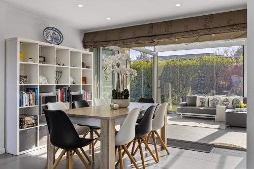 a dining room with a table and chairs at Sanctuary 53 Beautiful Views in Taupo