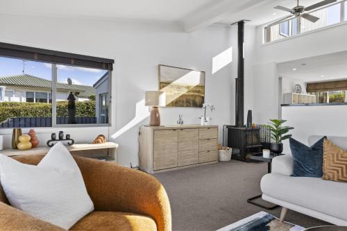 a living room with a couch and a chair at Sanctuary 53 Beautiful Views in Taupo