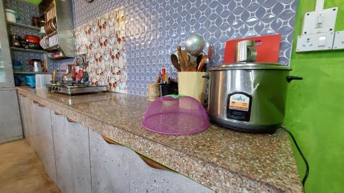 a coffee maker on a counter in a kitchen at Orange Villa in Rinchingpong