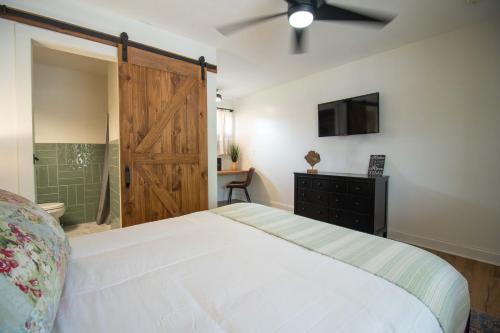 a bedroom with a bed and a sliding barn door at Carlton Marion Inn in Yellville