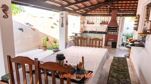 a table with a white table cloth on it in a kitchen at Casa na Praia na Ponta da Ilha in Cacha Pregos