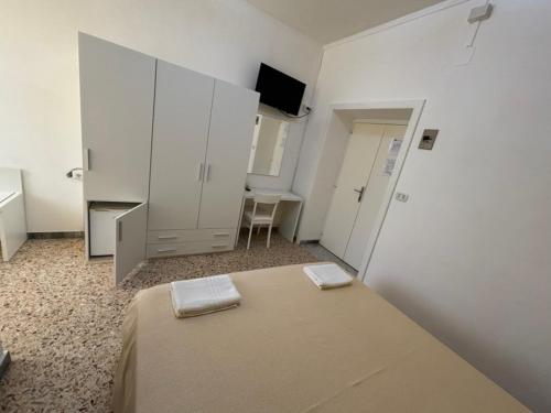a bedroom with a bed with two towels on it at Delfino in Marina di Camerota