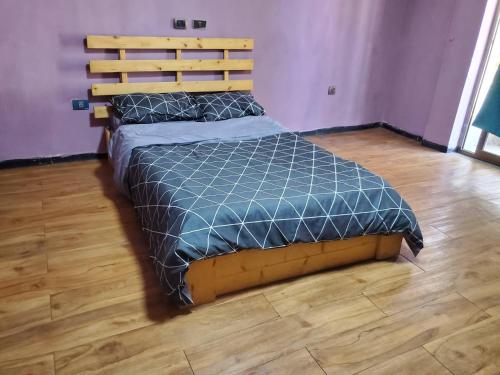 a bed in a bedroom with a wooden floor at Mad Vervet Backpackers Hostel in Addis Ababa